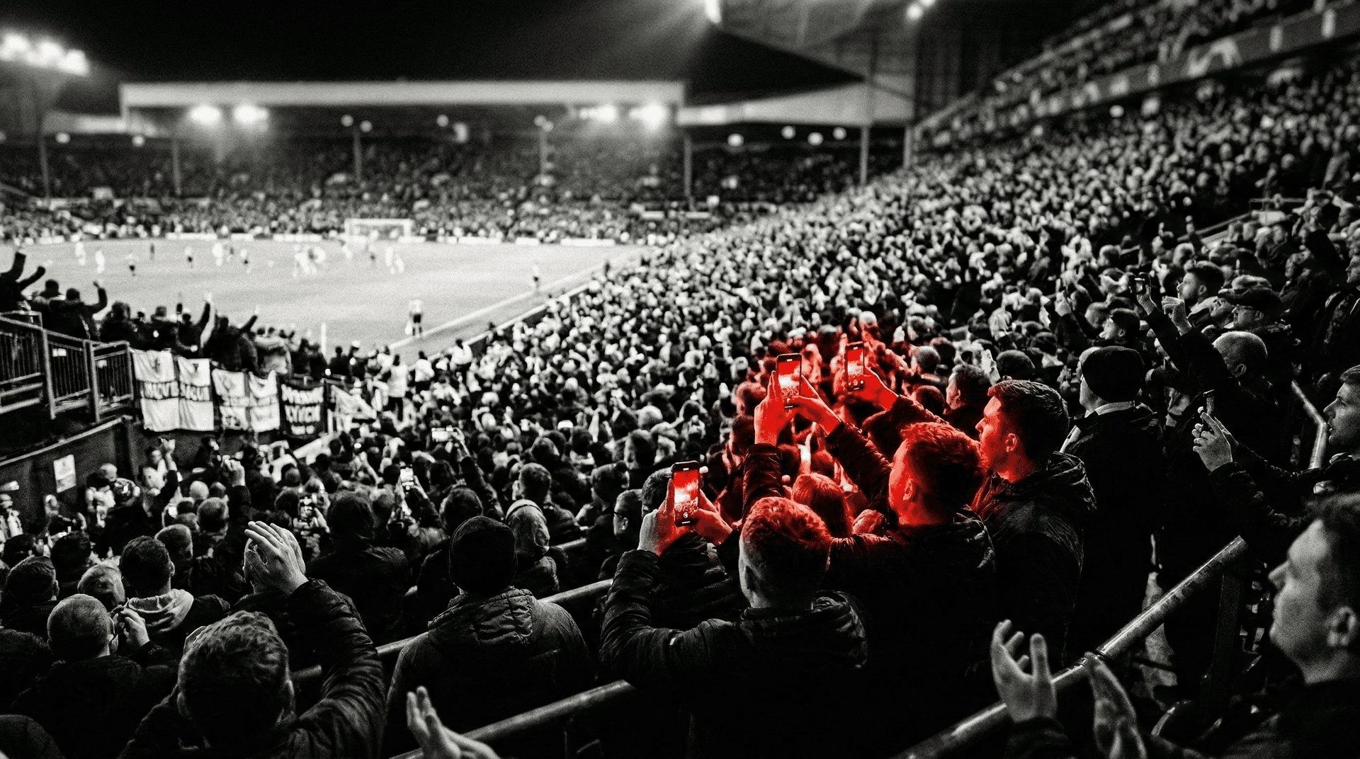 Group of fans capturing tournament moments on their phones